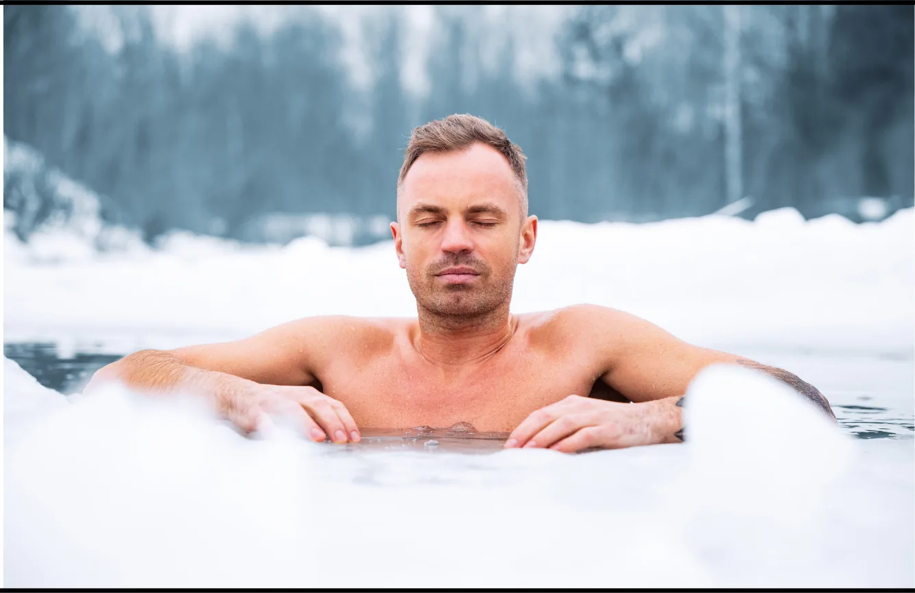 A swimmer resting at the edge of an opening in the ice.